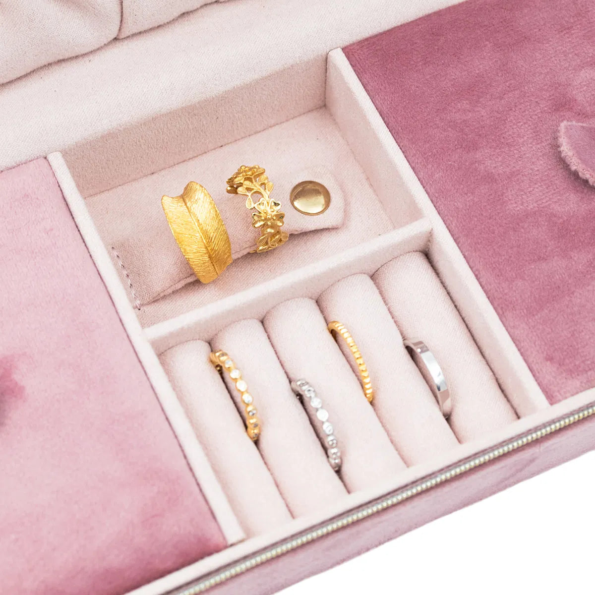 Image de la boîte à bijoux rose rectangulaire avec un gros plan sur les bagues